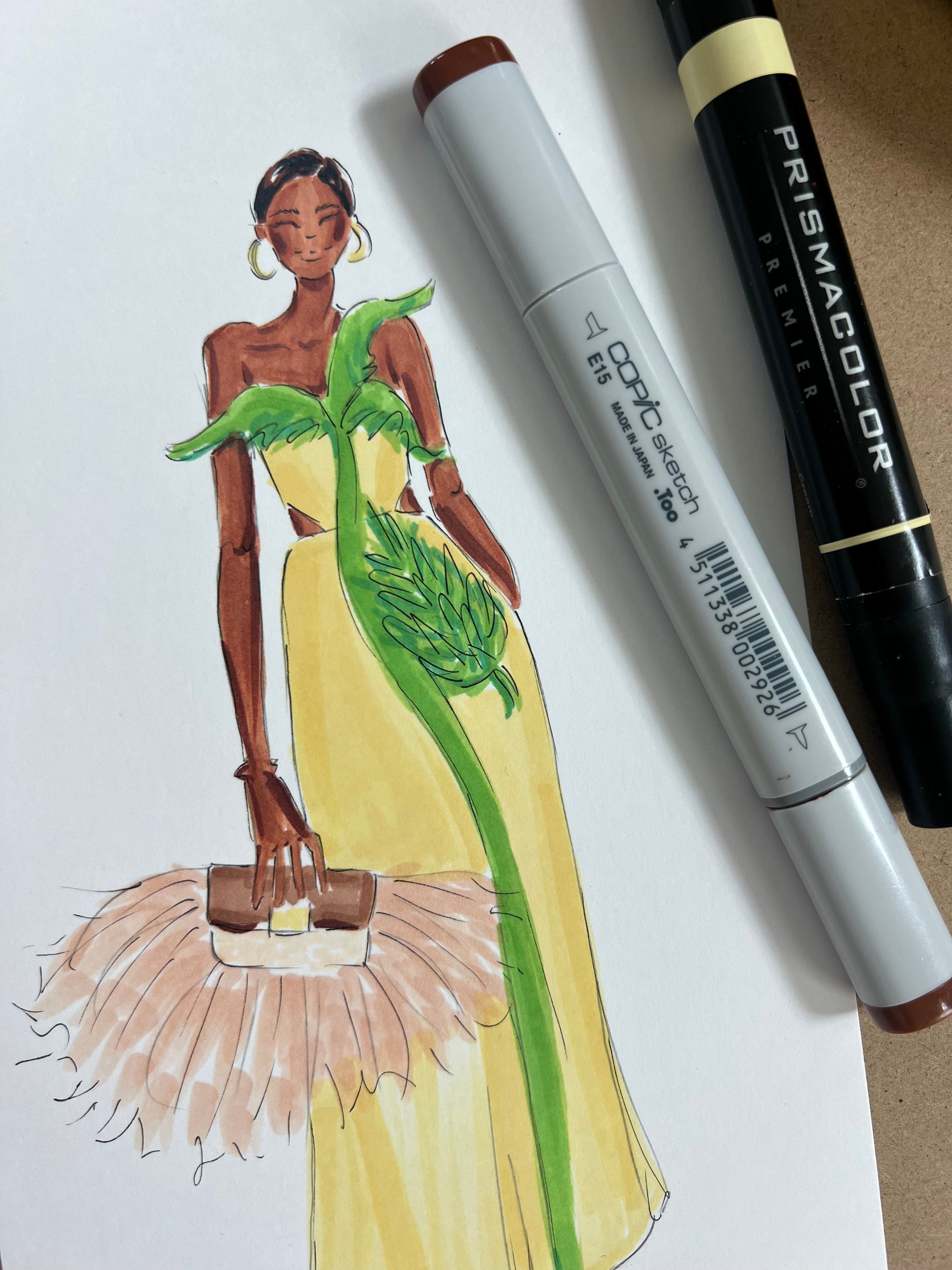 A fashion illustration of a woman in a tropical yellow gown with green leafy accents drawn  with Prismacolor and Comic markers.